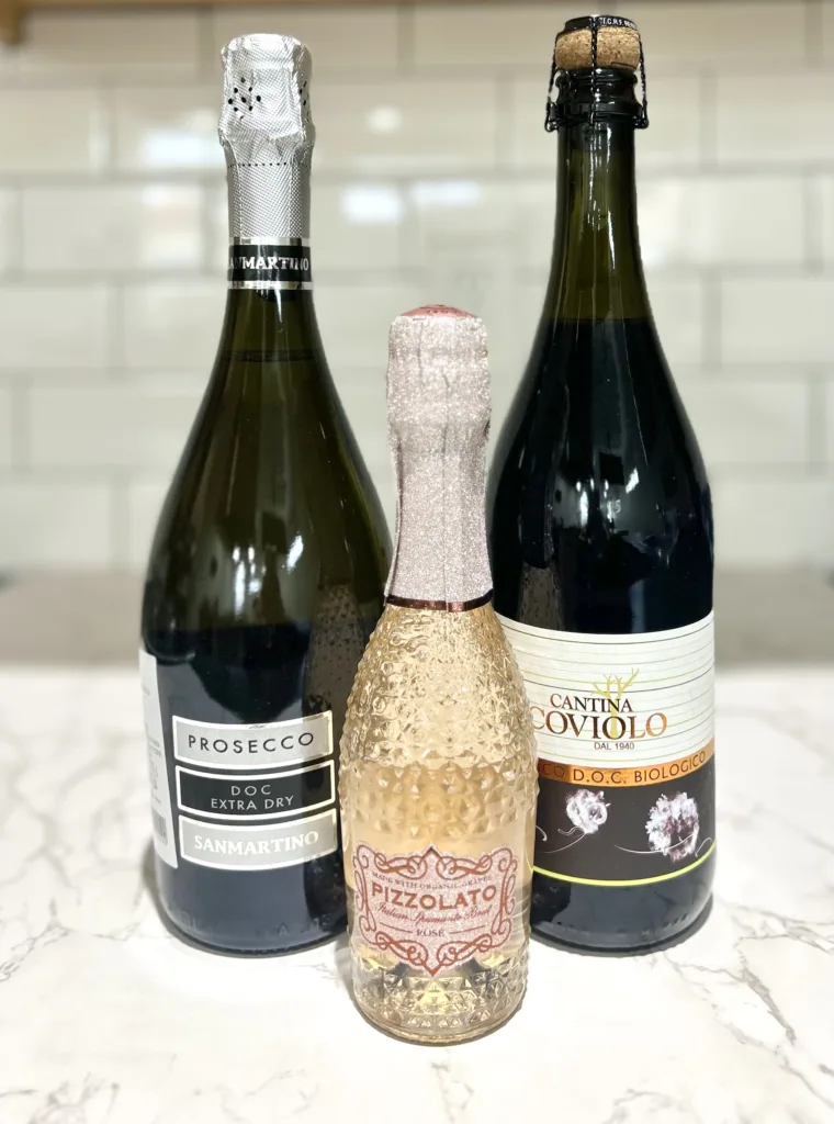 Three varieties of wine on a countertop
