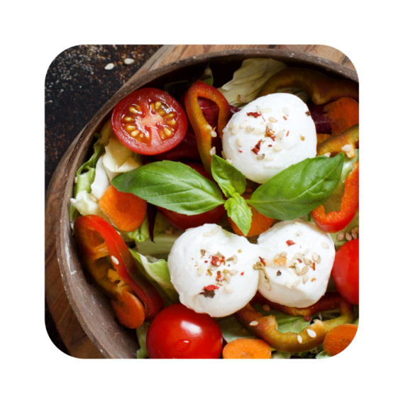 mozzarella ciliegine in a bowl of fresh mixed salad
