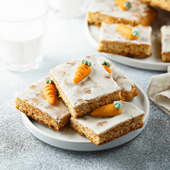 a plate full of homemade carrot cake squares
