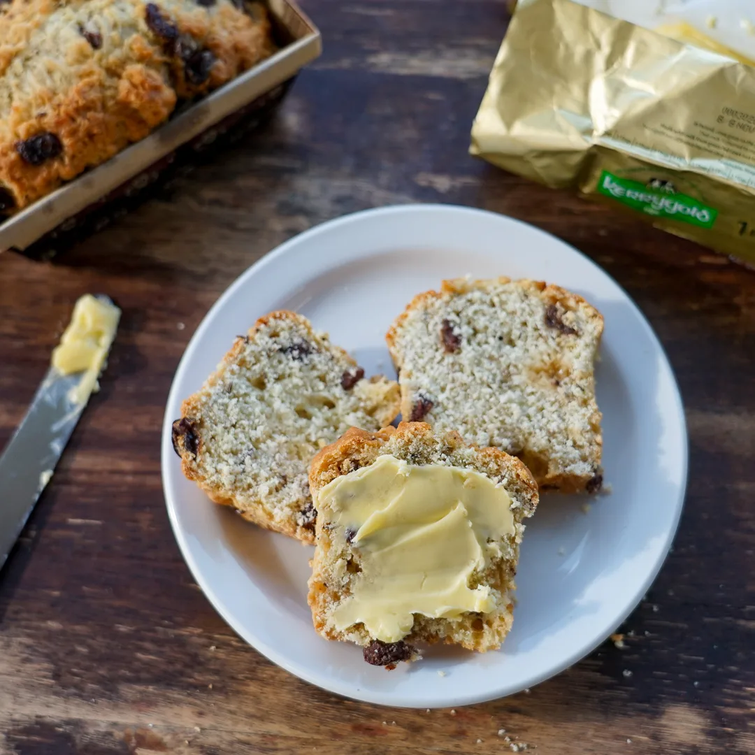Irish soda bread is buttered and ready to enjoy.