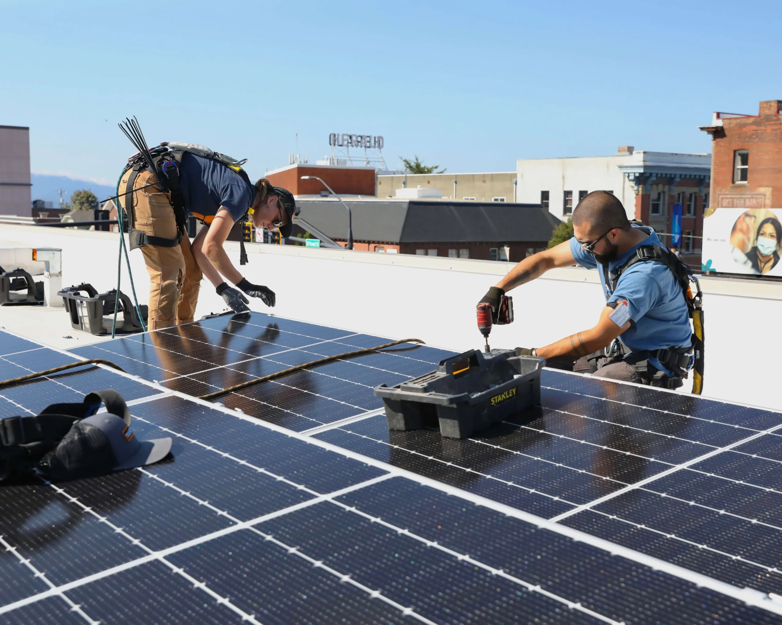 Ecotech employees install a solar panel.